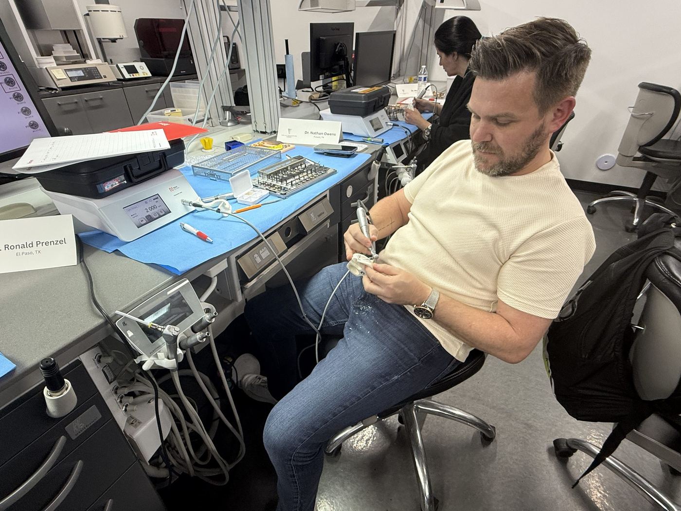 Dentists practicing implant placement on surgical models
