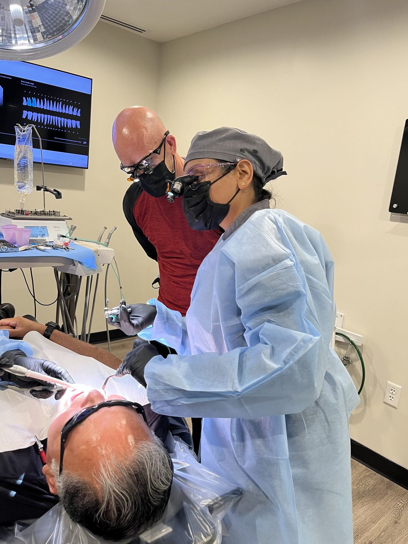 Dentist performing supervised live patient implant surgery at the Implant Education Company training center in Phoenix