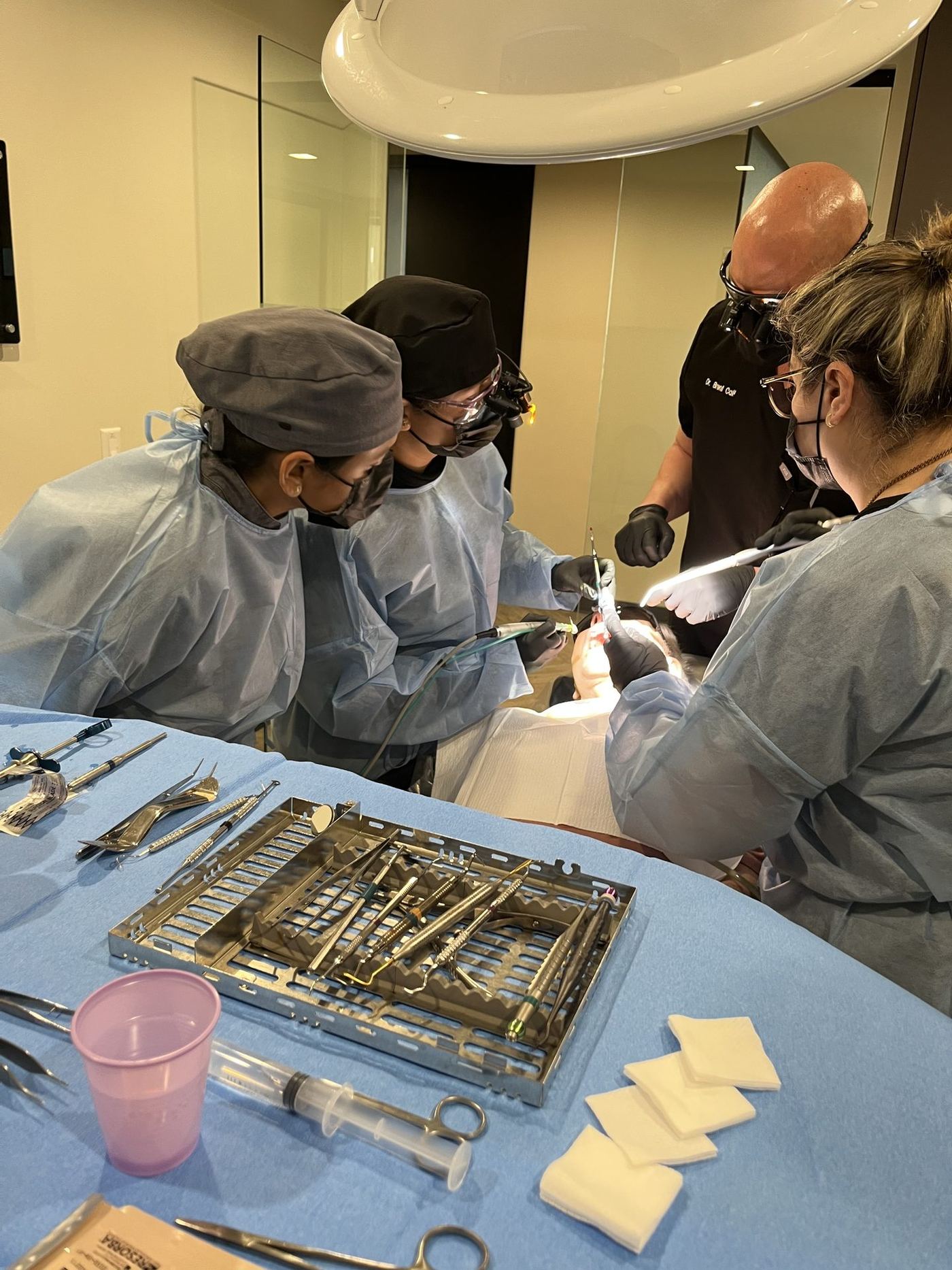 Dentist performing supervised live-patient implant surgery during the 3-day live-patient dental implant course in Phoenix