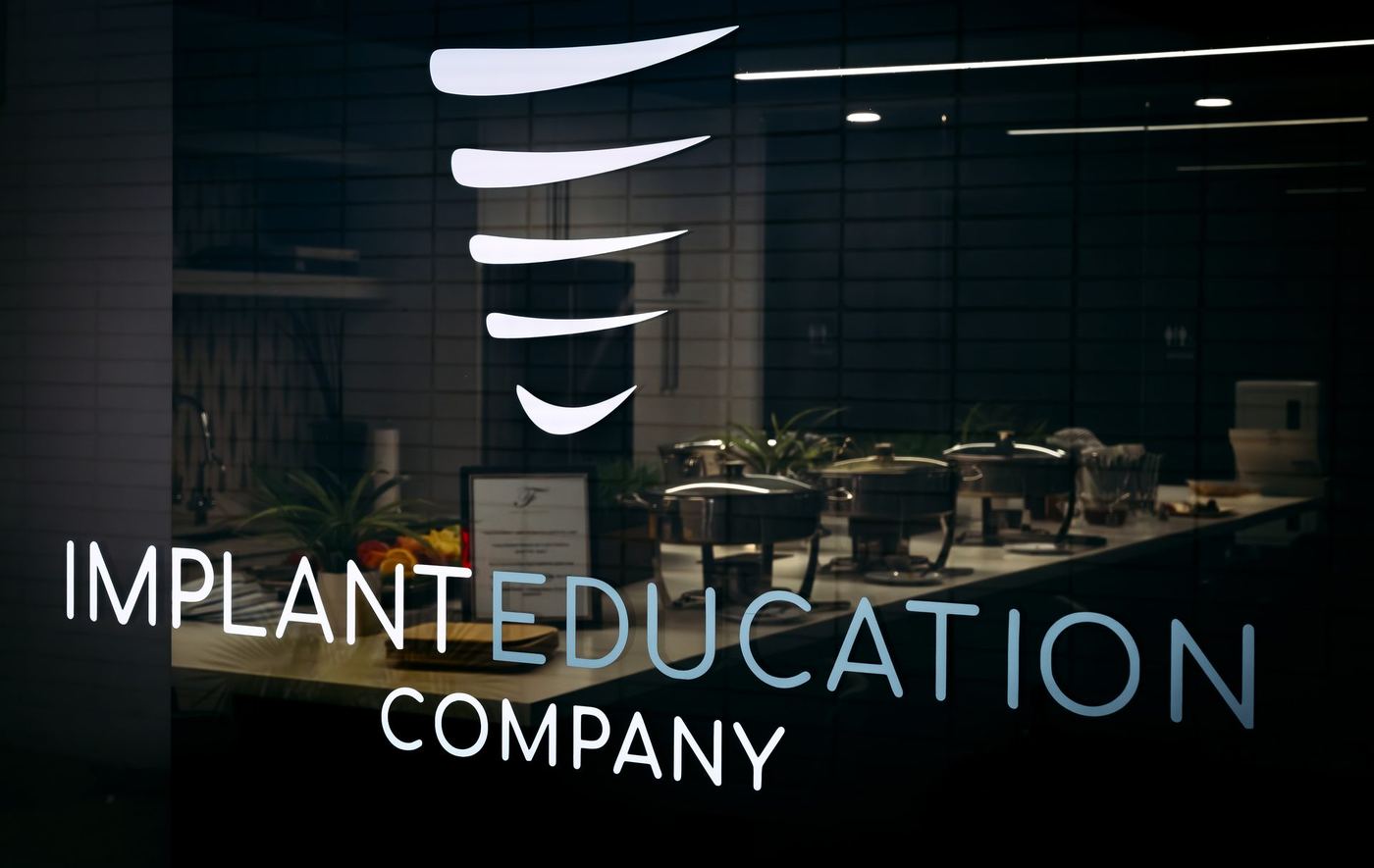 Implant Education Company logo displayed in the training center common area